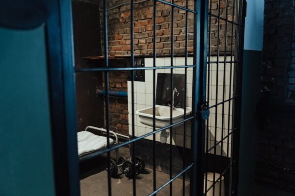 Prison cell interior - biometric health monitoring sensors and wearable devices track inmate vital signs to prevent in-custody deaths