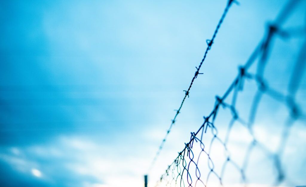 Prison corridor representing rehabilitation-focused corrections reform and electronic monitoring as reentry alternative - Brennan Center 2026 report